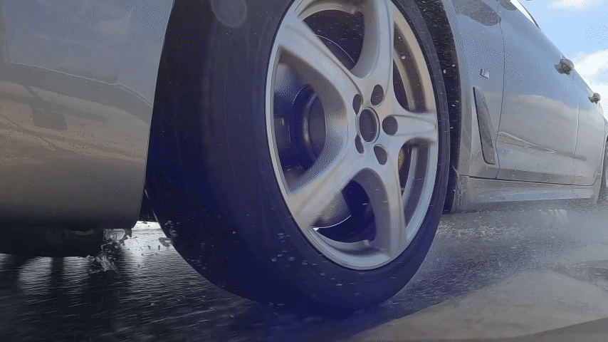 GIF demonstrating car driving on wet road, safely stopping, with close-up shots of the Vredestein Ultrac Pro tyre in action.